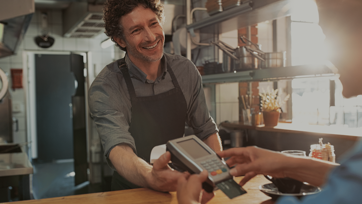 A graphic of a man paying with a credit card