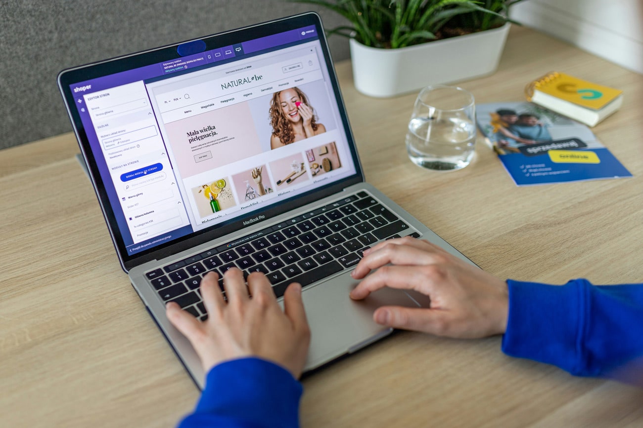 Someone setting up an eCommerce site on a laptop