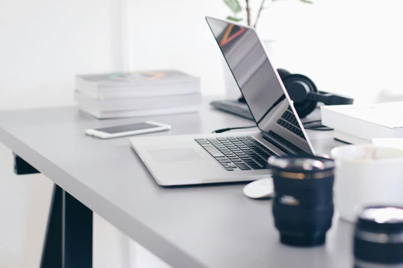 A half closed laptop on the desk of a small online business