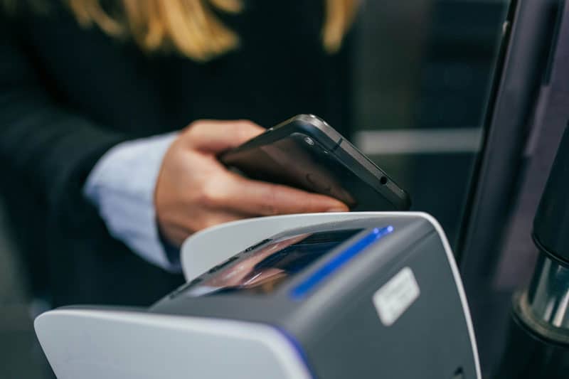 A woman using her phone to pay