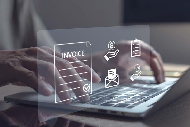 a hologram of an invoice on top of a man using a laptop