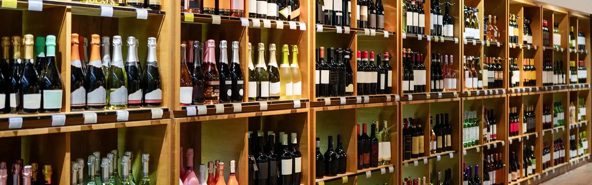 alcohol bottles on wooden shelving