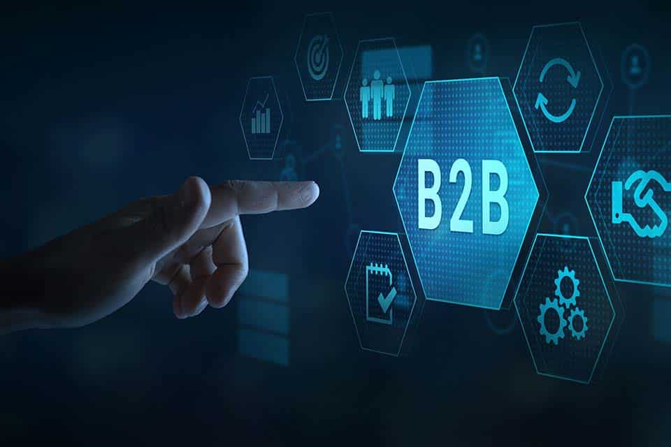 a finger reaching towards a hologram that says "B2B"