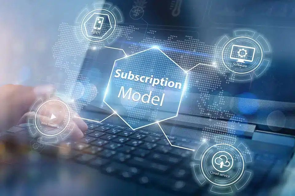 a laptop in the background of a hologram that says "subscription model"