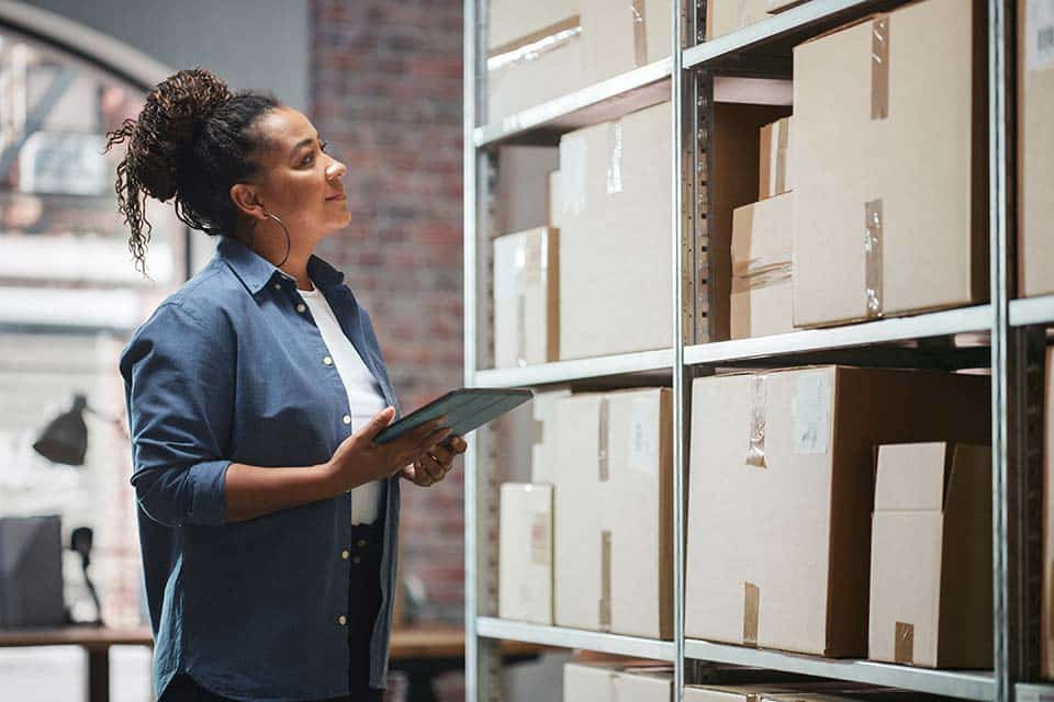 drop shipper looking at boxes of inventory