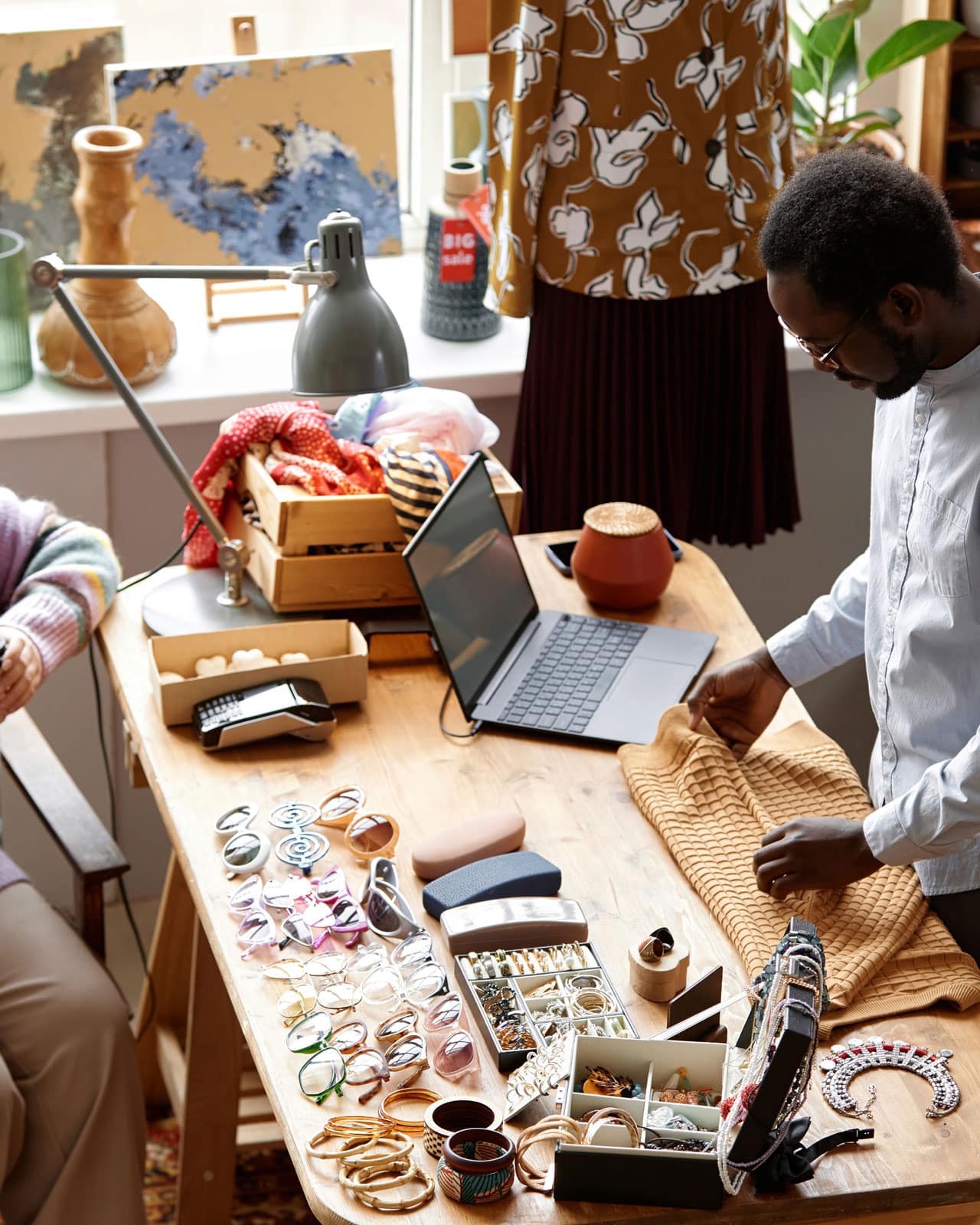 pawn shop counter with gold items being appraised