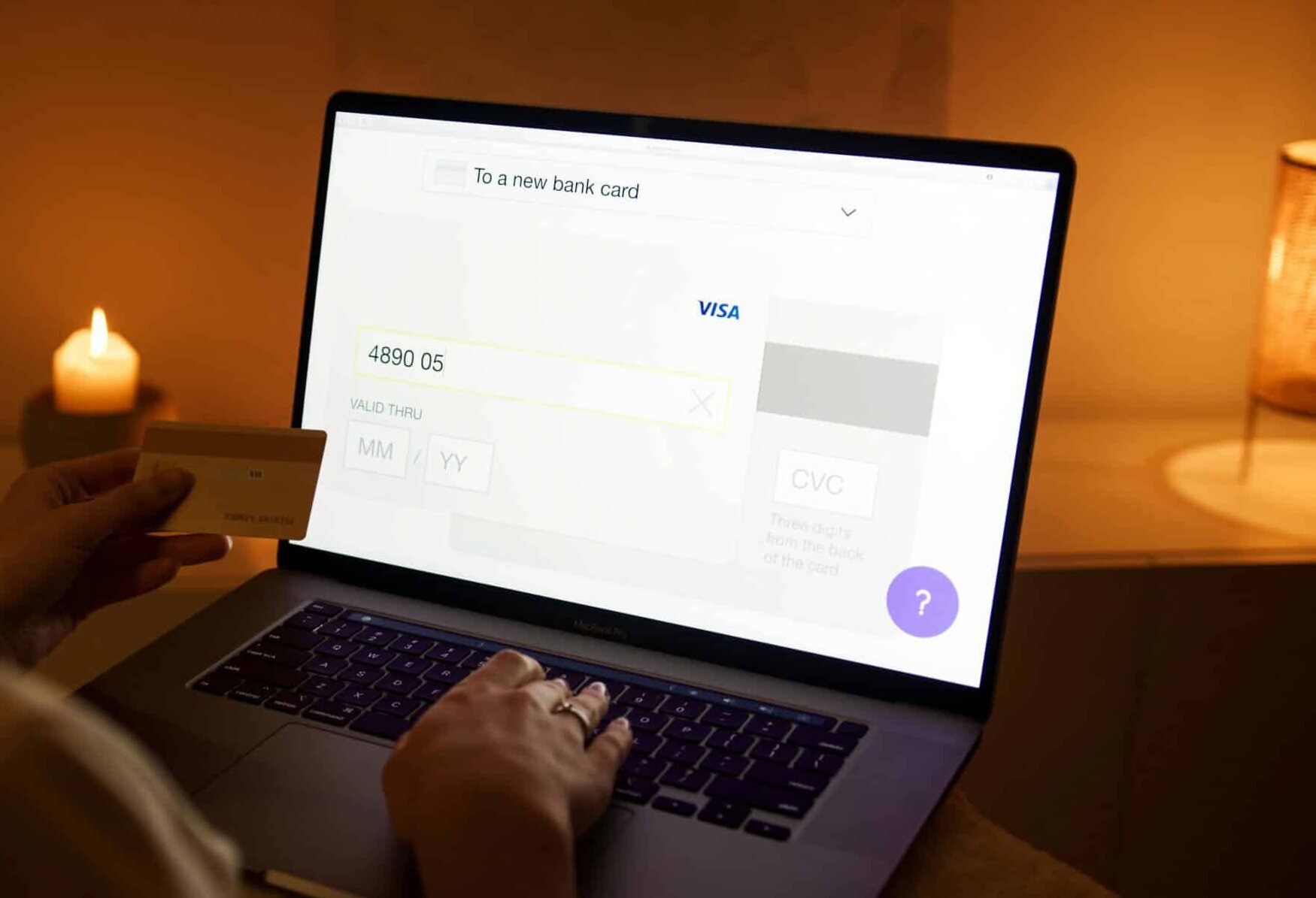 Person using laptop with credit card