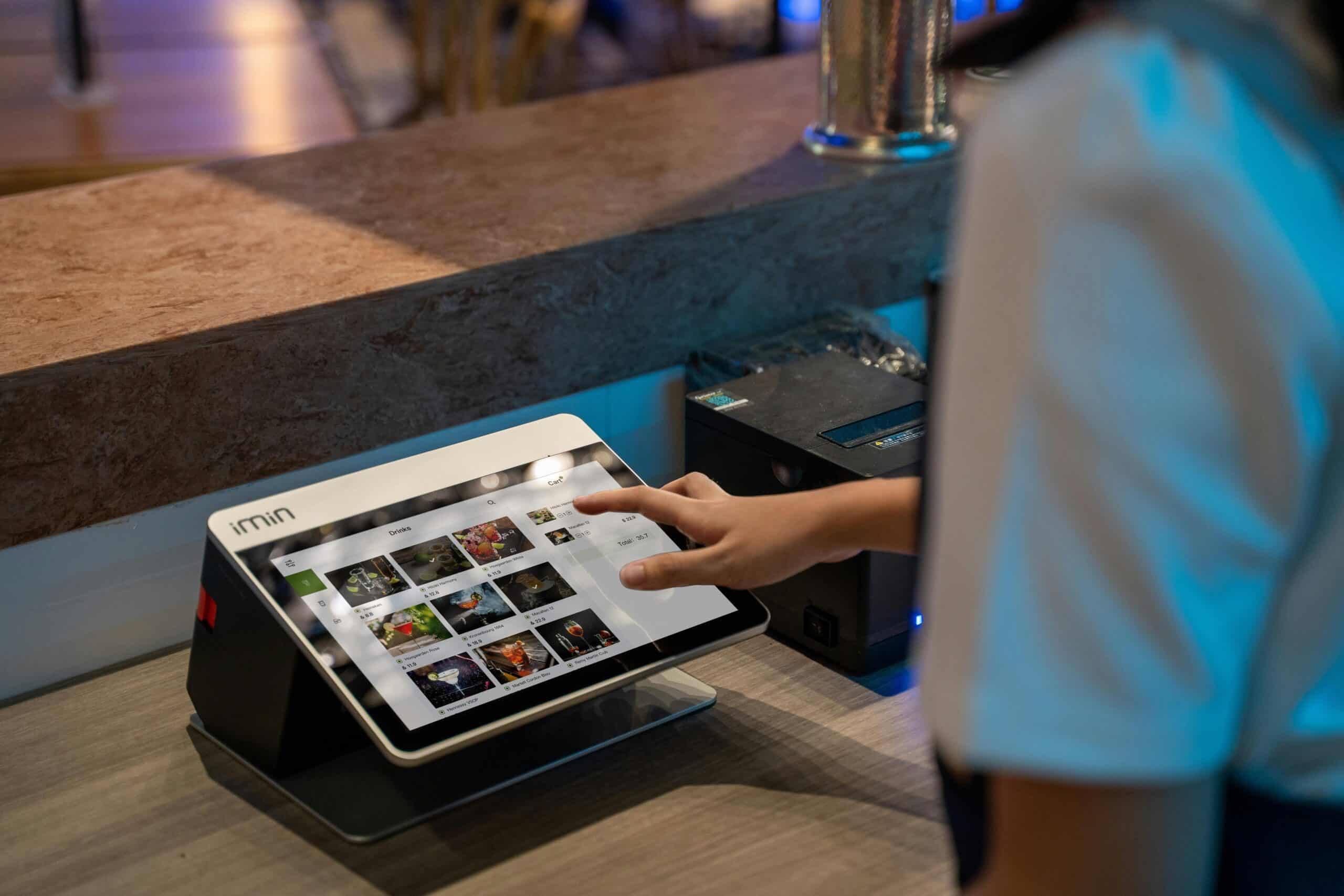 A person using a POS system to checkout