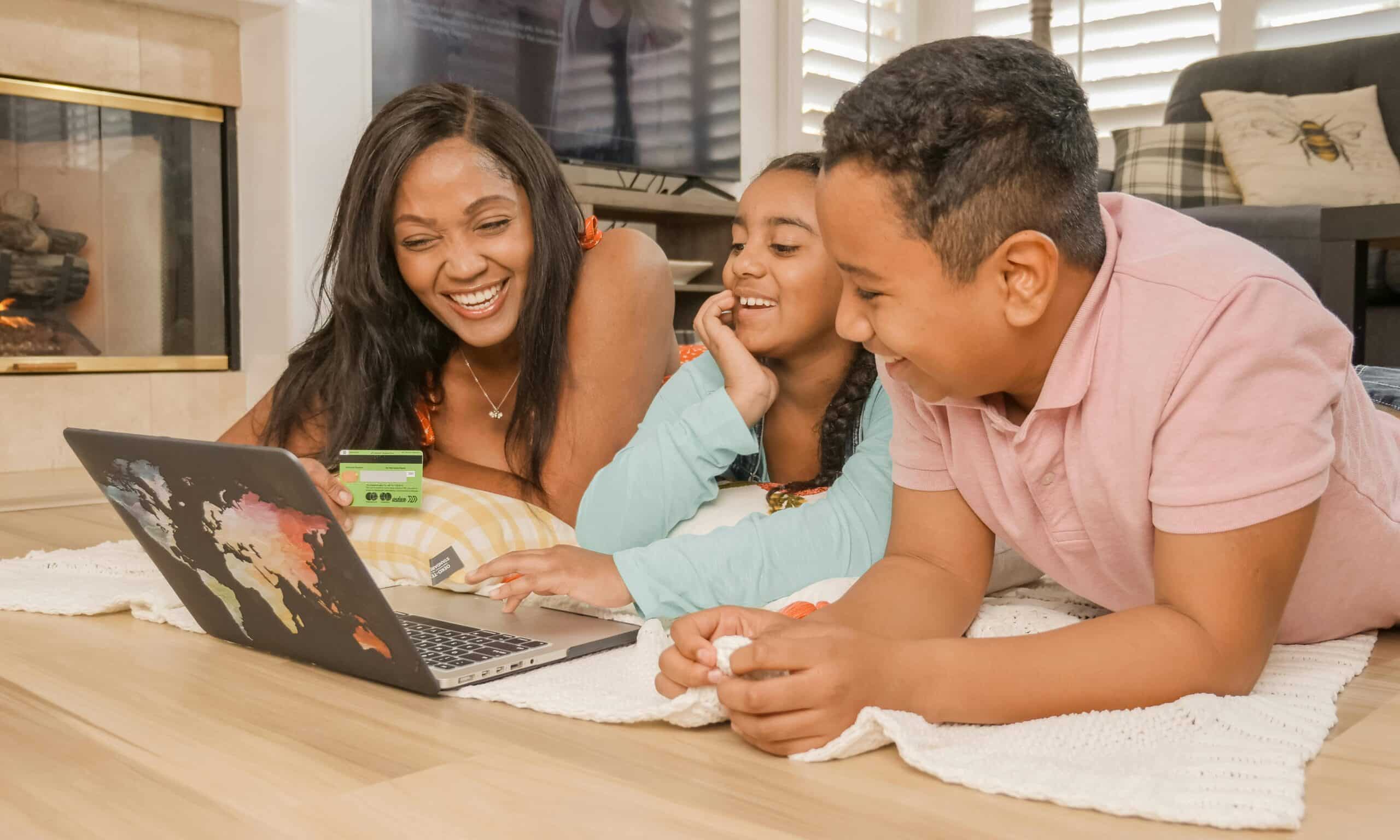 Family using laptop with credit card
