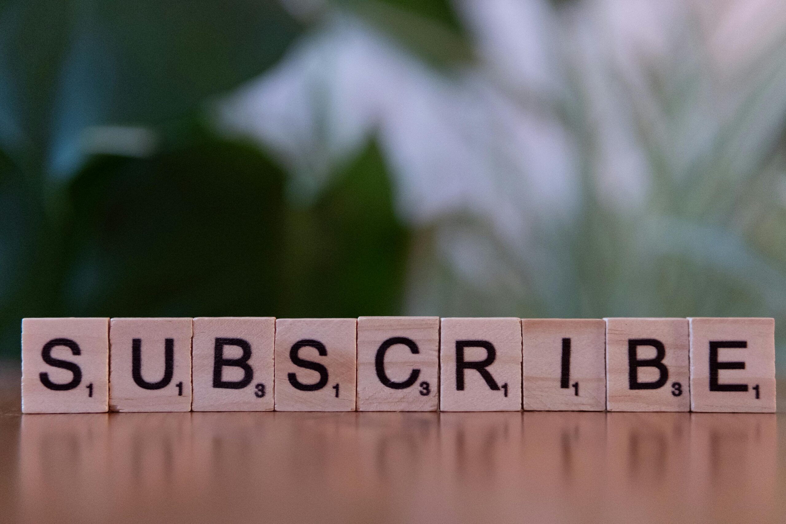 The word subscribe written on scrabble tiles to indicate a subscription service