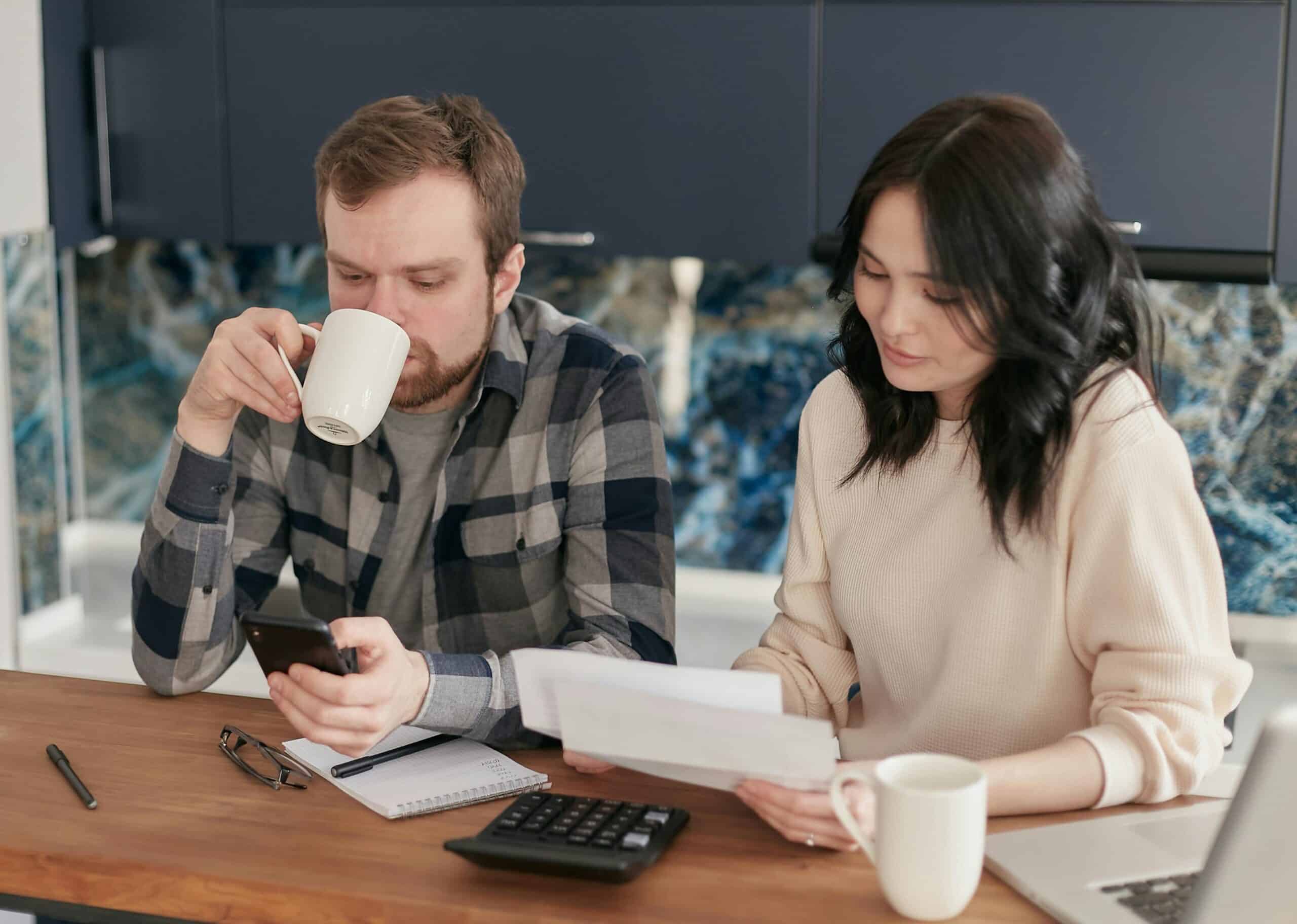A couple looking over bills as they decide payment for a subscription service