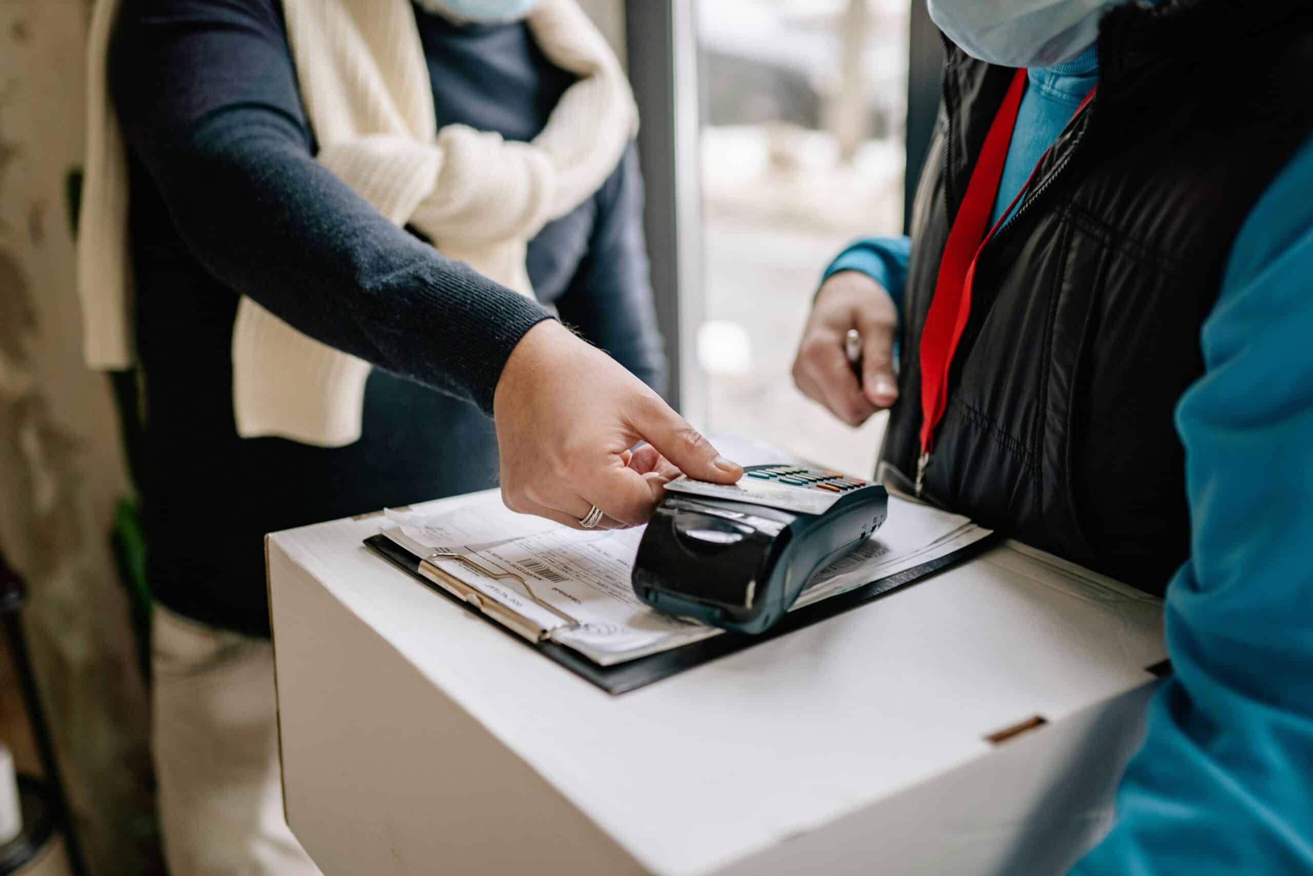 A person using contactless payment at a POS