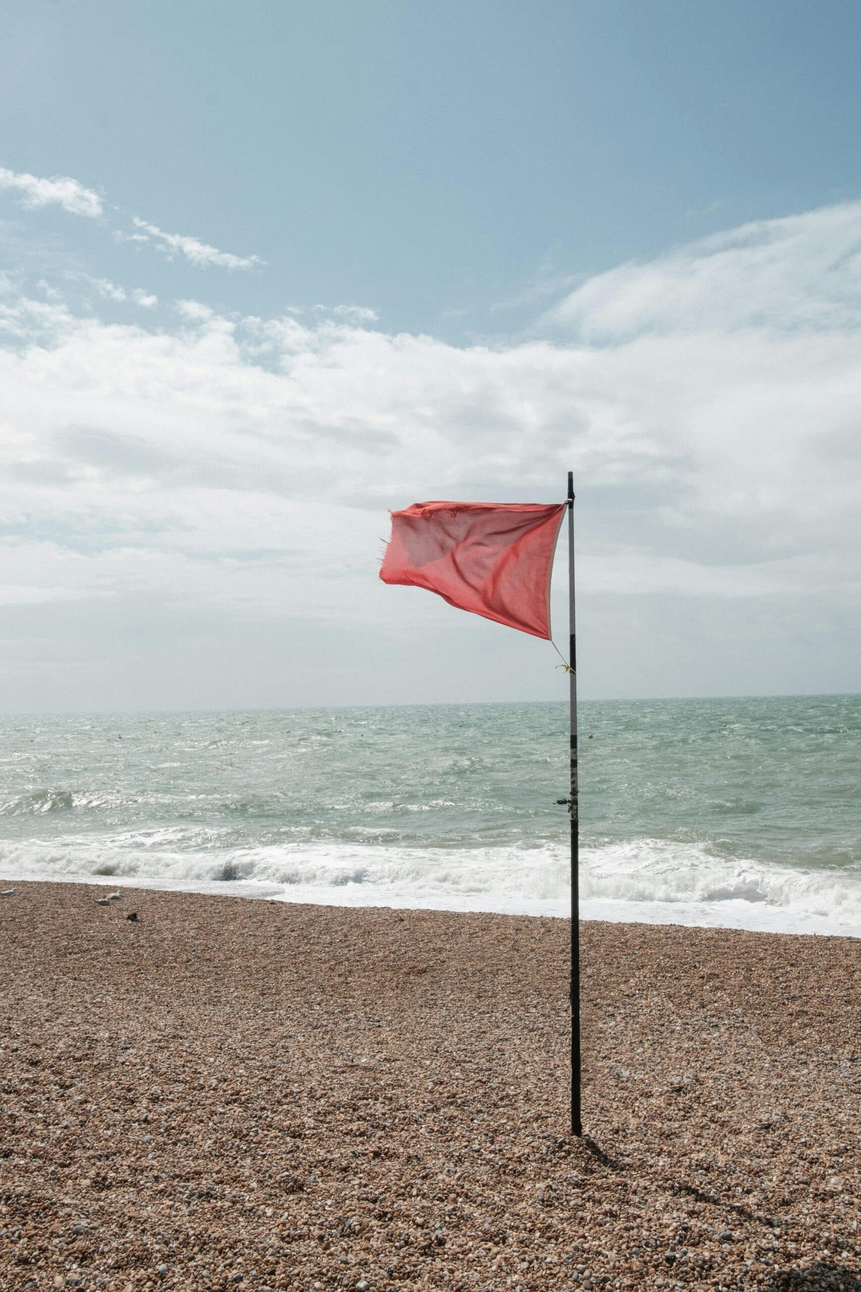 Red flag on beach showing warning or risk