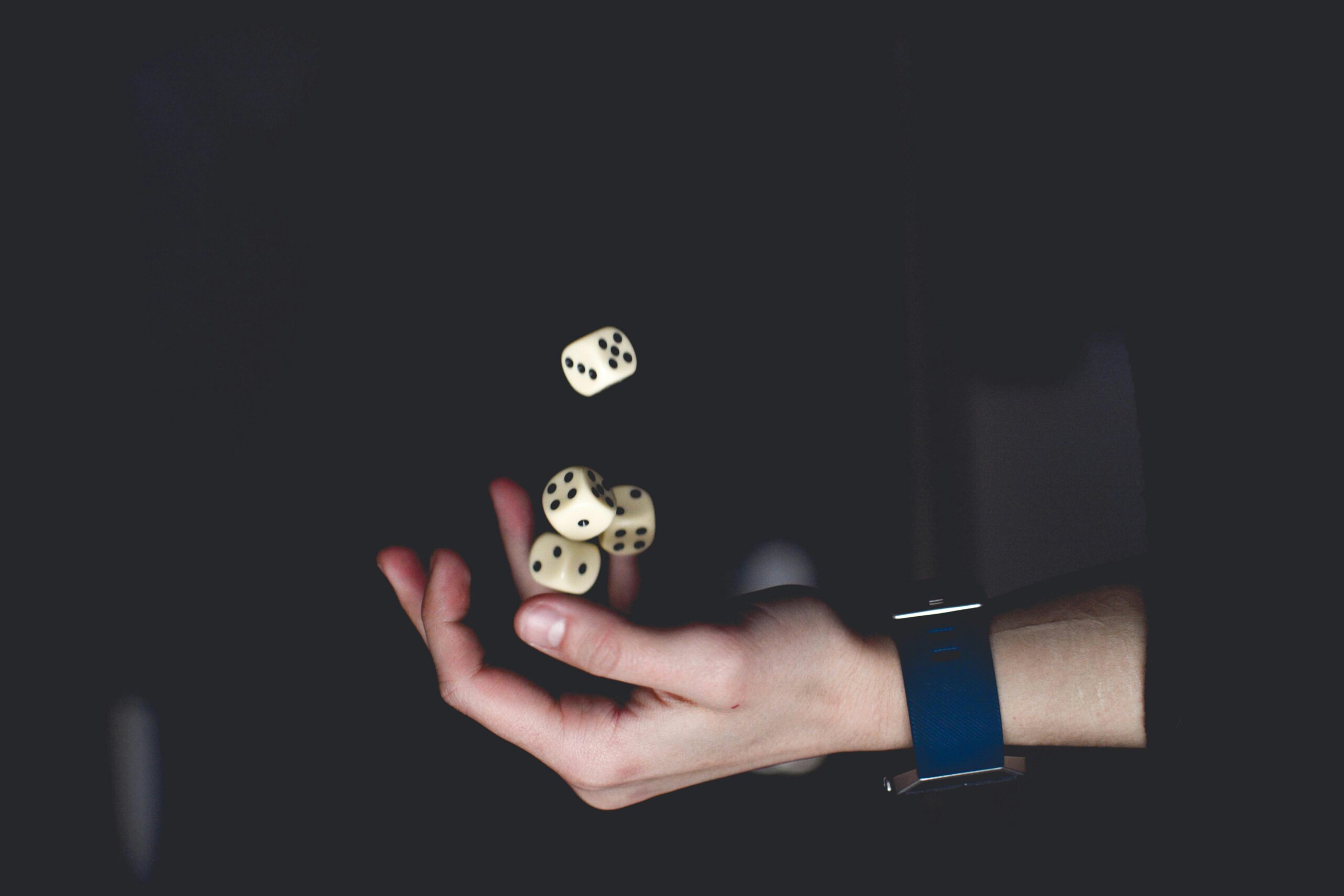 Hand tossing a handful of dice
