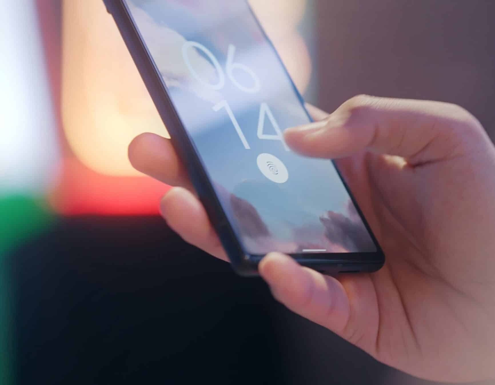 A person using their thumb on a fingerprint scanner on their mobile phone