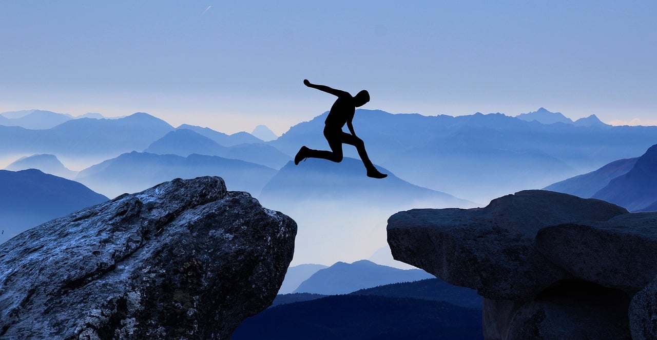 Man jumping between rocks