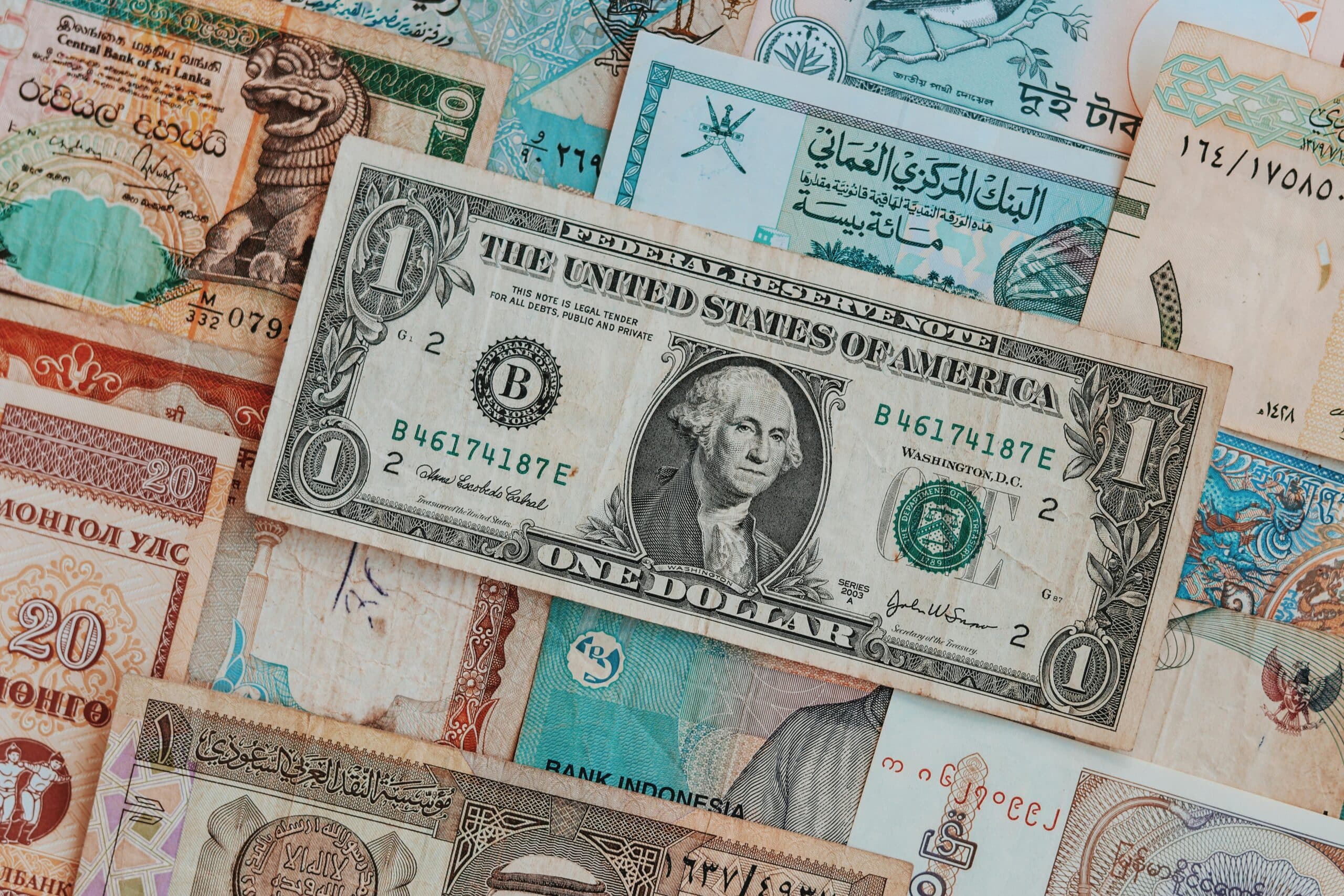 U.S. dollar bill and international currency showing global payment processing
