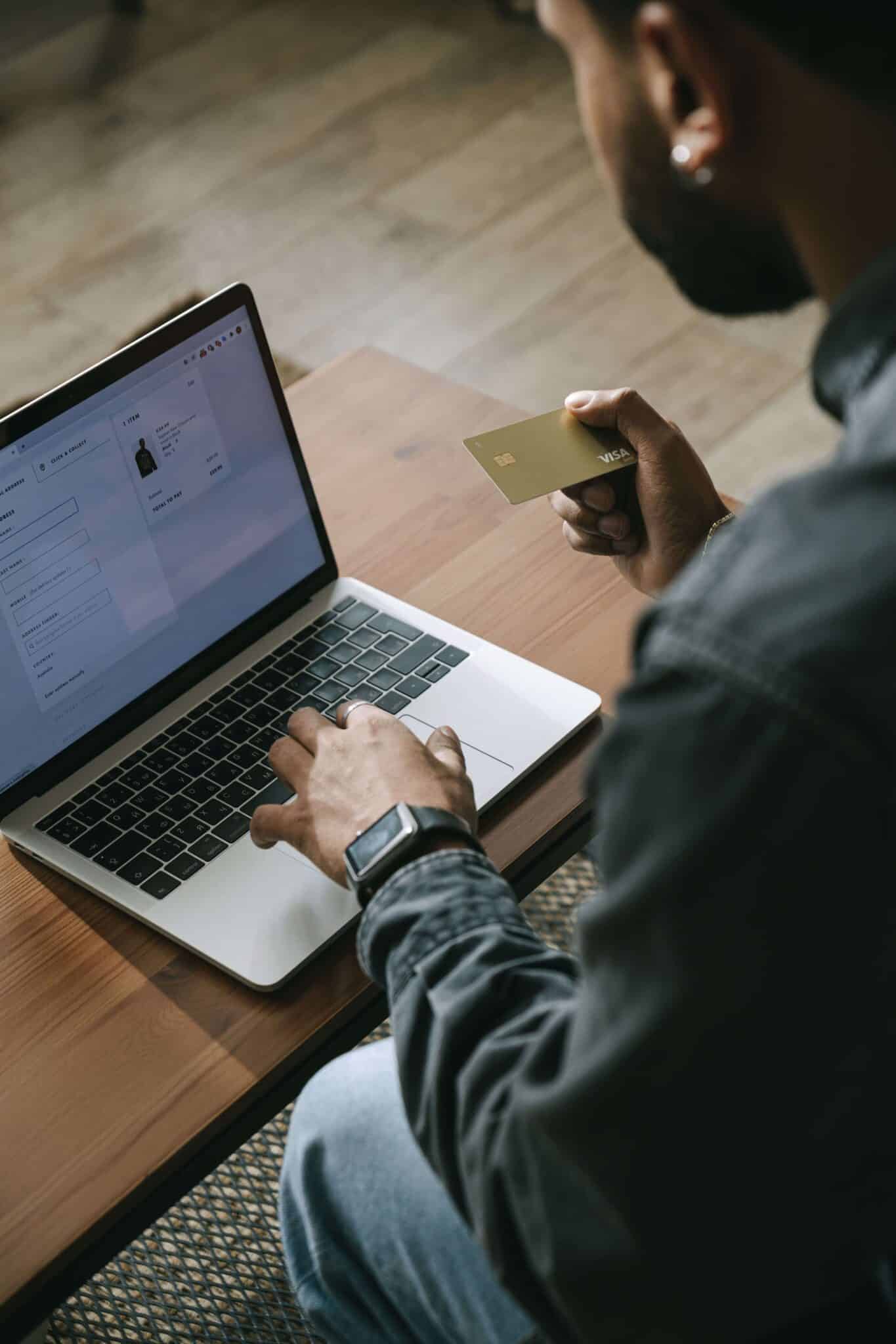 Man buying something on his laptop with Visa credit card